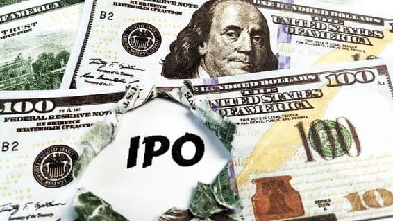 Лист бумаги с надписью 'IPO' на фоне 100-долларовых купюр США.