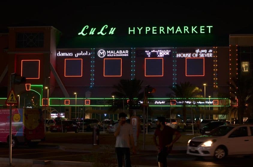 Вход в гипермаркет LuLu с видной неоновой вывеской сверху.