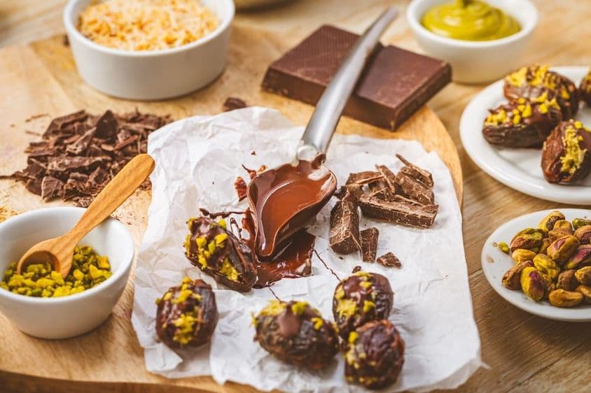 Вкусный десерт, финик с начинкой из фисташкового мусса, популярная альтернатива шоколаду в Дубае.