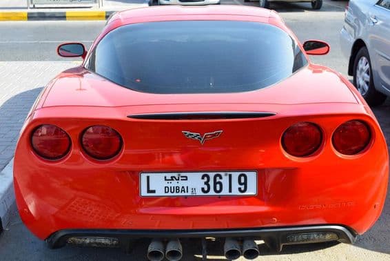 Красный Chevrolet Corvette с дубайским номерным знаком.