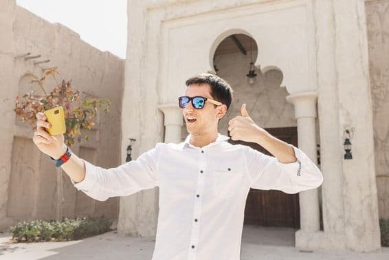 Мужчина записывает видеоблог в старом районе Дубай Крик.