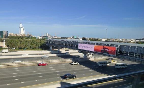 Дорога в Дубае, крупный наружный рекламный щит у дороги.